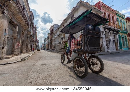 Havana, Cuba - May 14, 2019: Bicycle Taxi Driver Riding In The Streets Of Old Havana City During A V