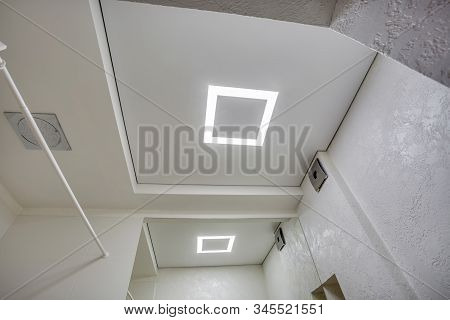 Halogen Spots Lamps On Suspended Ceiling And Drywall Construction In In Empty Room In Apartment Or H