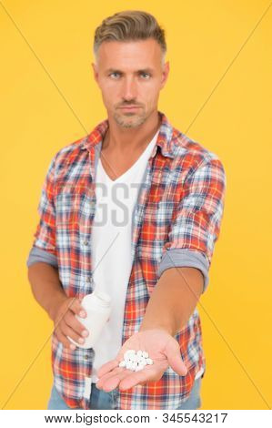 Food Additives Vitamins Male Health. Vitamin Complex. Handsome Man Presenting Product Selective Focu