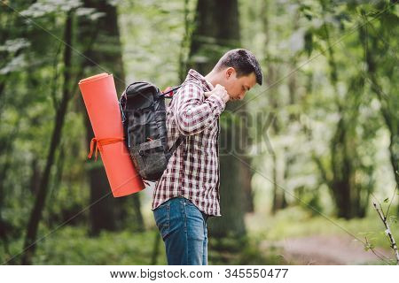 Hiker Holding His Camping Backpack. Traveler Opening Backpack While Traveling In Beautiful Wood. The
