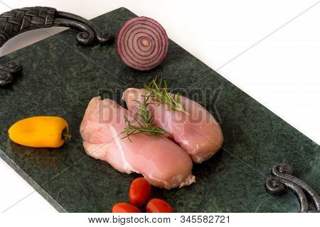 Raw Chicken Breast With Rosemary, Vegetables  On Green Marble Cutting Board. Chickenbreast