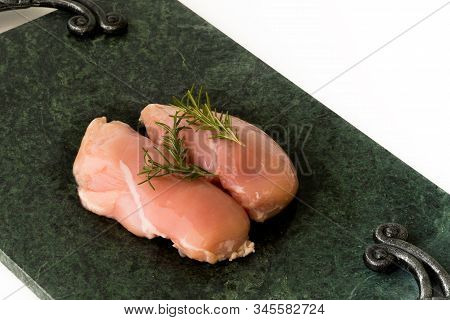 Raw Chicken Breast With Rosemary On Green Marble Cutting Board. Chickenbreast.  Cooking Concept