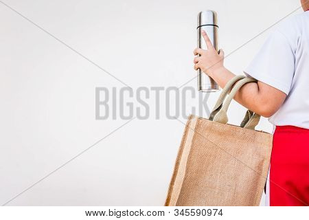 An Asian Girl Is Using A Cloth Bag In Place Of A Plastic Bag In The Concept Of Reducing Plastic Wast
