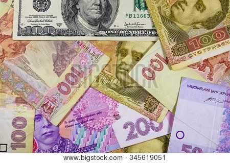 American One Hundred Dollars Banknote On Many Ukrainian Hryvnas