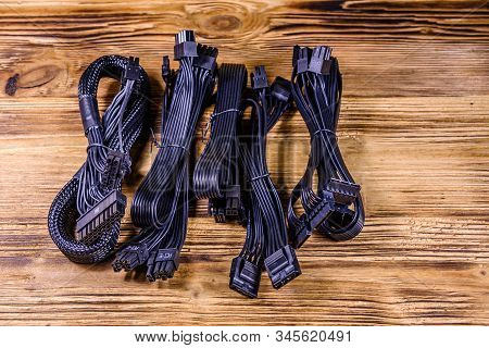 Set Of Computer Psu Cables On Wooden Background