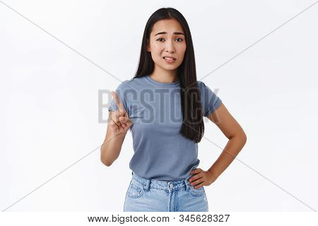 Skeptical And Arrogant Sassy Young Asian Woman Shaking Finger In Rejection, Give Refusal And Looking