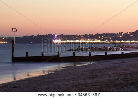 A View From Boscombe Beach Looking Toward Bournemouth Pier At Twilight