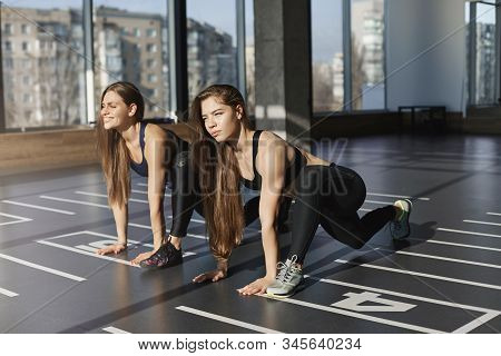 Ready Steady Go. Motivated And Focused Good-looking Two Women, Sportswomen Stretching, Warm-up Body 