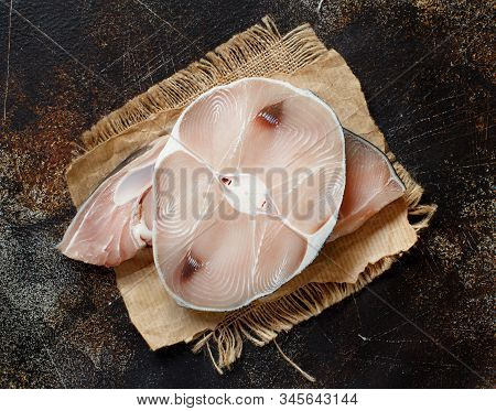 Two Shark Steak On A Dark Board Top View