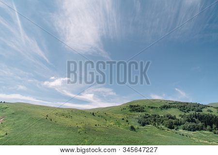 Summer View Of The Plateau Lago Naki With Snow. Beautiful Clouds And Mountain In A Blue Haze.