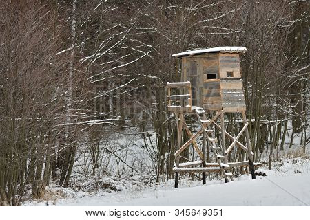 Wooden Hunting Lodge For Hunting In The Meadow In Winter