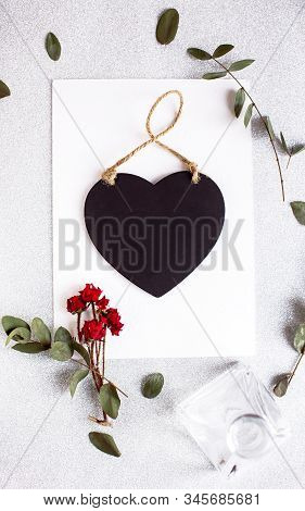 Background With Copy Space Blank On Table With Black Heart, Eucalyptus Branch, Roses Flowers And Lea