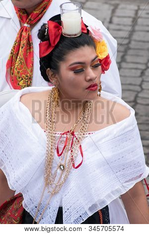 XALAPA, VERACRUZ, MEXICO- NOVEMBER 24, 2019: Young woman dancing and dressed with traditional clothe