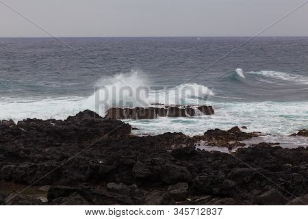 Beautiful Nature Scene Of Sea Wave Hitting On The Black Stone Shoreline At Jeju Island, South Korea.