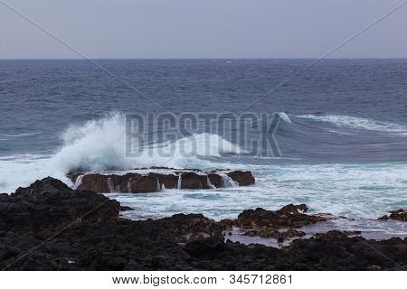 Beautiful Nature Scene Of Sea Wave Hitting On The Black Stone Shoreline At Jeju Island, South Korea.
