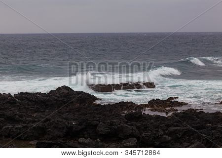 Beautiful Nature Scene Of Sea Wave Hitting On The Black Stone Shoreline At Jeju Island, South Korea.