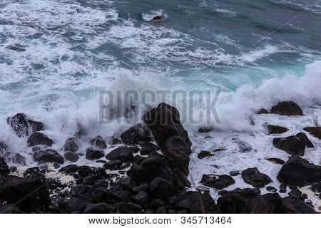 Beautiful Nature Scene Of Sea Wave Hitting On The Black Stone Shoreline At Jeju Island, South Korea.