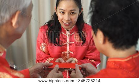 Daugther Give Red Envelop To Father Mother In Chiense New Year
