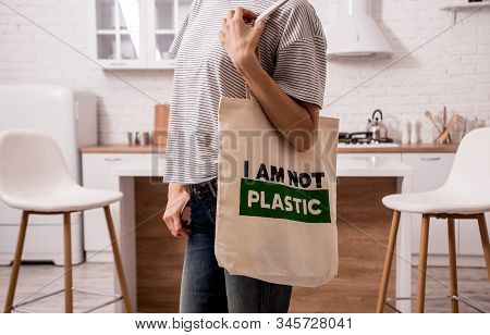 Young Girl Holding A Cloth Bag. At The Kitchen. I Am Not Plastic. Campaign To Reduce The Use Of Plas