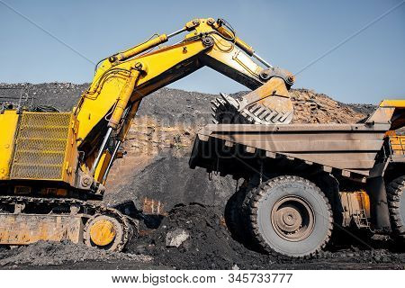 Open Pit Mine Industry, Excavator Loading Coal On Big Yellow Mining Truck For Anthracite