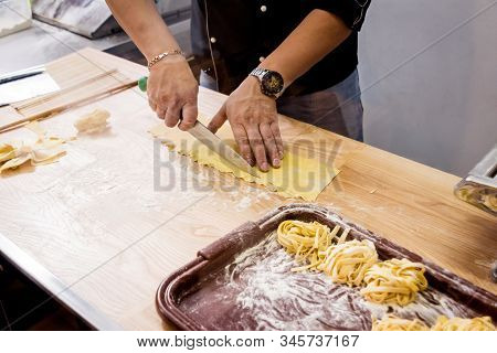 Chef Rolling Dough With A Pasta Machine. Pasta Maker Machine. Homemade Italian Style Cuisine. Restau