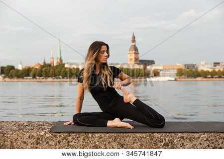 Yoga Meditation And Wellness Lifestyle Concept. Fit Slim Woman Practicing Yoga Exercises Near River 