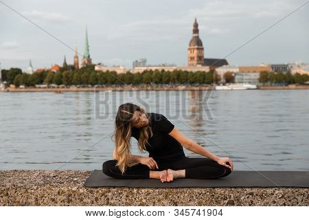 Yoga Meditation And Wellness Lifestyle Concept. Fit Slim Woman Practicing Yoga Exercises Near River 
