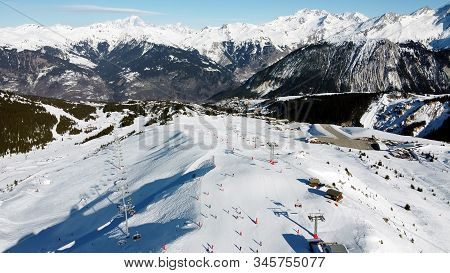 Majestic Winter Aerial Landscape And Ski Resort With Typical Alpine Wooden Houses In French Alps, Le