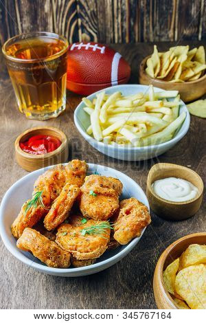 Table Fof Tasty Snacks And Beer Prepared For Watching Sports On Tv. Selective Focus