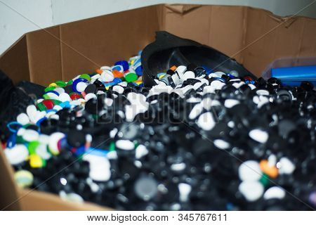 Waste Heap From Plastic Bottle Caps On Waste Sorting Station. Large Pile Of Colored Stoppers Destine
