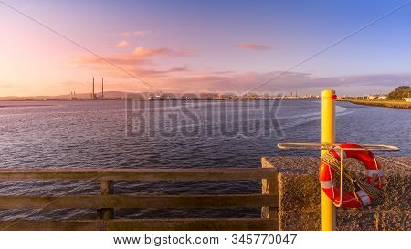 View On Dublin Port With Poolbeg Power Plant, Tall Chimneys And Dock Cranes From Bull Island. Lifebu
