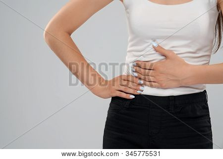 Clolse Up Of Incognito Caucasian Woman In Casual Suit Posing Over Gray Isolated Background And Touch