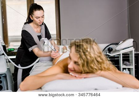 Vacuum Roller Massage, And Hardware Correction Of The Figure. Young Woman Doctor Cosmetologist Doing
