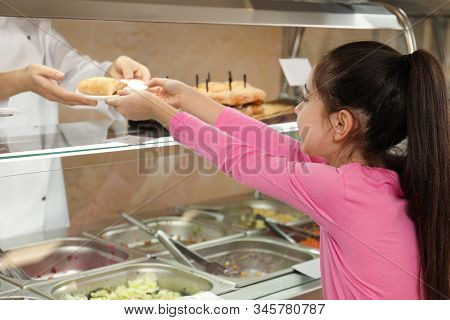 Woman Giving Plate With Tasty Food To Girl In School Canteen