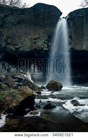 Beautiful Waterfall And Mossy Rocks Leading Down To A Stream