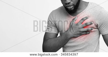 Valvular Heart Disease. Cropped Of Black Man Touching His Left Side Chest, White Background, Panoram