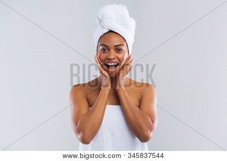Excited Young Black Lady Wrapped In Towel Expressing Amazement Over Grey Background, Amazing Deals F