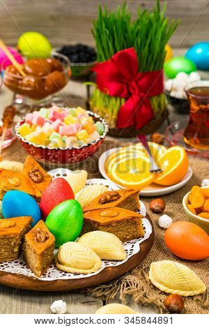 Novruz Ramadan In Azerbaijan. Colored Eggs, Wheat Springs For Easter And Traditional Sweets. Selecti