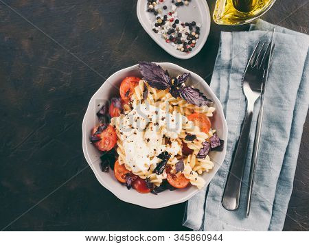 Tasty Italian Fusilli Pasta With Cherry, Mozarella Or Buratta Cheese And Fresh Basil. Dish With Past
