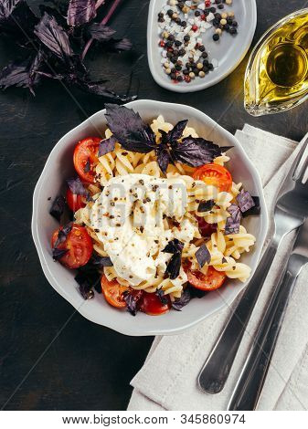 Tasty Italian Fusilli Pasta With Cherry, Mozarella Or Buratta Cheese And Fresh Basil. Dish With Past