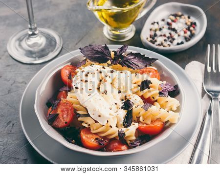Tasty Italian Fusilli Pasta With Cherry, Mozarella Or Buratta Cheese And Fresh Basil. Dish With Past
