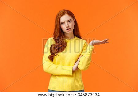 Skeptical And Troubled, Uncertain Young Redhead Woman Cant Understand How Resolve Proble, Shrugging 