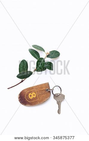 The Key To The Room, Hotel Room. The Number 8 On The Keychain. Old Key On A White Background. The Co