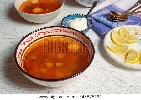 Rustic Bowl With Hodgepodge Meat Soup Made Of Various Kind Of Meat, Sausages And Vegetables