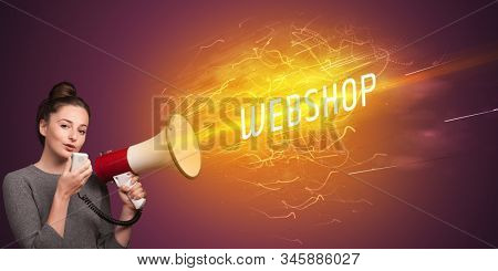 Young girld shouting in megaphone with WEBSHOP inscription, online shopping concept