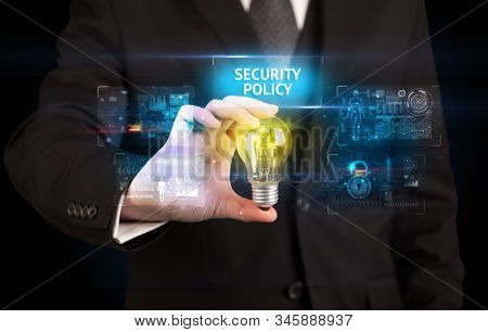 Businessman holding lightbulb with SECURITY POLICY inscription, online security idea concept