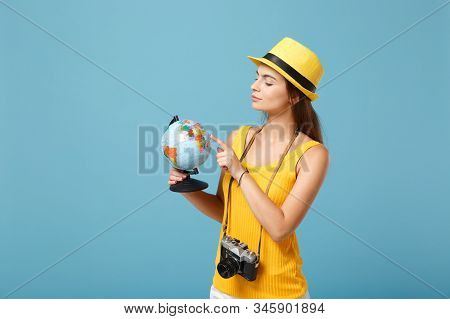 Traveler Tourist Woman In Yellow Summer Casual Clothes, Hat With Globe, Camera Isolated On Blue Back