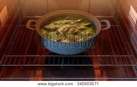 A Close View Of A Pot Of Thai Green Curry Inside A Hot Household Oven   - 3d Render
