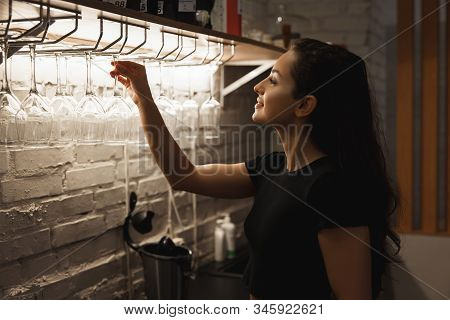 Barista Woman Standing Behind The Bar Setting Cleadn Wineglasses, Barista Work Routine