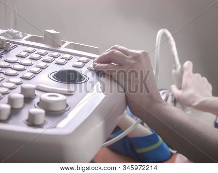 Doctors Hands, Using An Ultrasound Scanner, Examine The Patients Organs